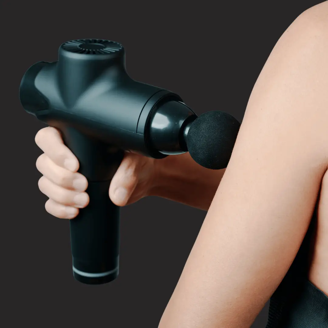 A massage gun hold by a person and doing a muscle massage.